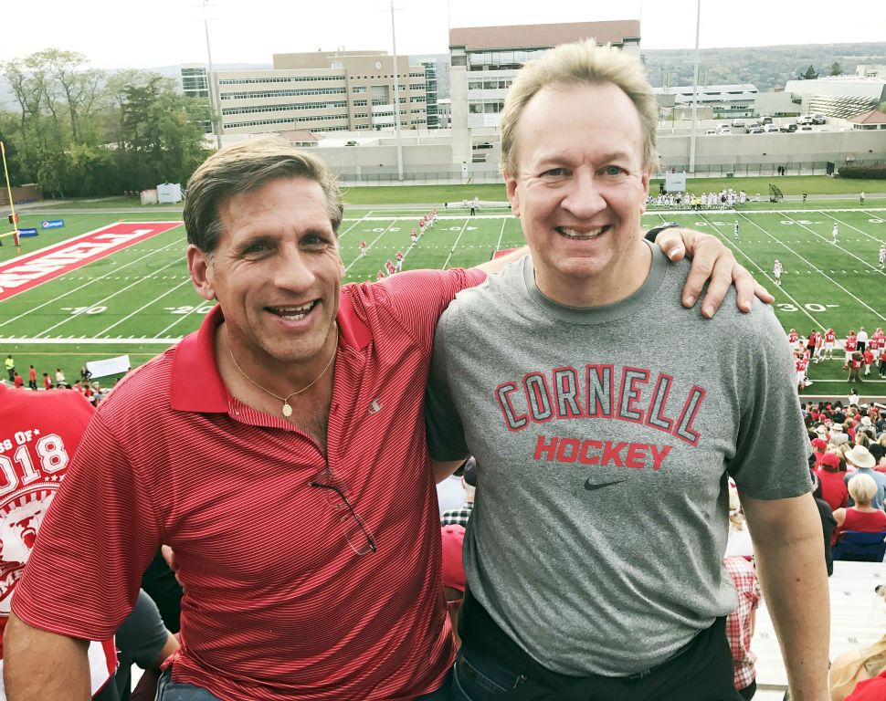 Jim Spaller '86 and Jaan Janes '85 root on the Big Red.